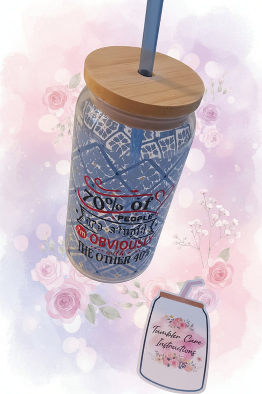 Tumbler with a wooden lid and straw on a white surface, with a smaller image of a tumbler care instruction sheet.